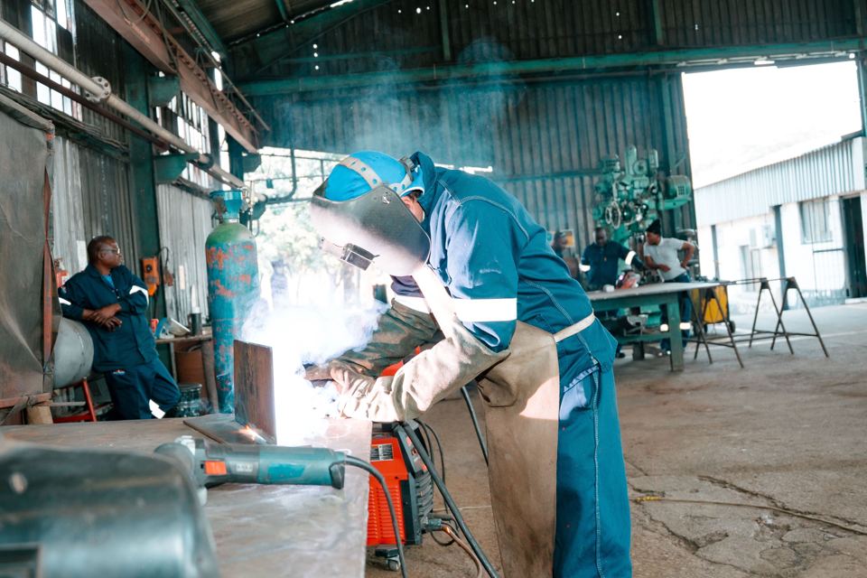 Welder fabricating pipe spools in the workshop